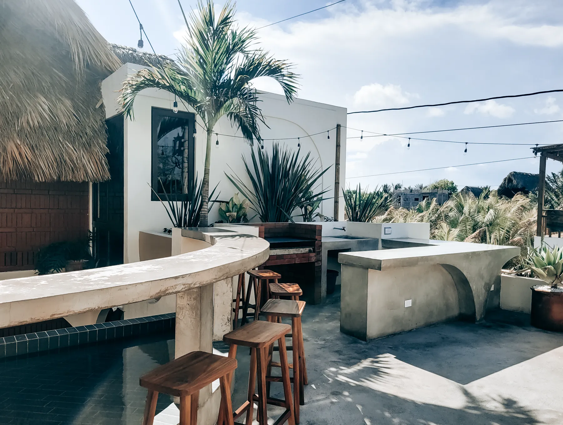 Courtyard plunge pool, palapa, and shell mark at Caracola Boutique Hostel
